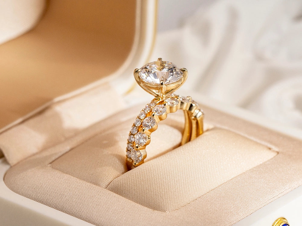 Gold ring with diamonds on a beige jewelry box