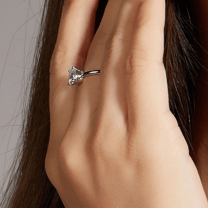 Elegant moissanite 1.0CT engagement ring on a hand, showcasing its brilliance and amazing value. 💍✨