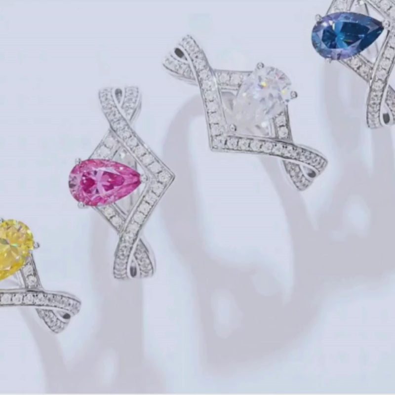 Colorful pear-cut Moissanite chevron rings in yellow, pink, white, and blue 💍✨ Perfect for engagement or wedding! Amazing value!