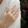 Hand wearing the Amaris 1.0CT Round Moissanite Ring 💍✨, perfect for weddings and engagements with amazing value!