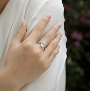 Hand wearing the Amaris 1.0CT Round Moissanite Ring 💍✨, perfect for weddings and engagements with amazing value!