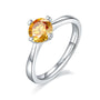 Elegant round-cut moissanite engagement ring💍 in polished silver, showcasing a vibrant orange stone✨. Great value for weddings!