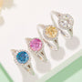 A stunning display of four colorful Moissanite rings showcasing blue, pink, yellow, and clear stones, perfect for engagement and weddings. 💍✨