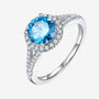 Stunning moissanite engagement ring with a blue center stone and sparkling pave band. 💍✨ Gorgeous choice for weddings!