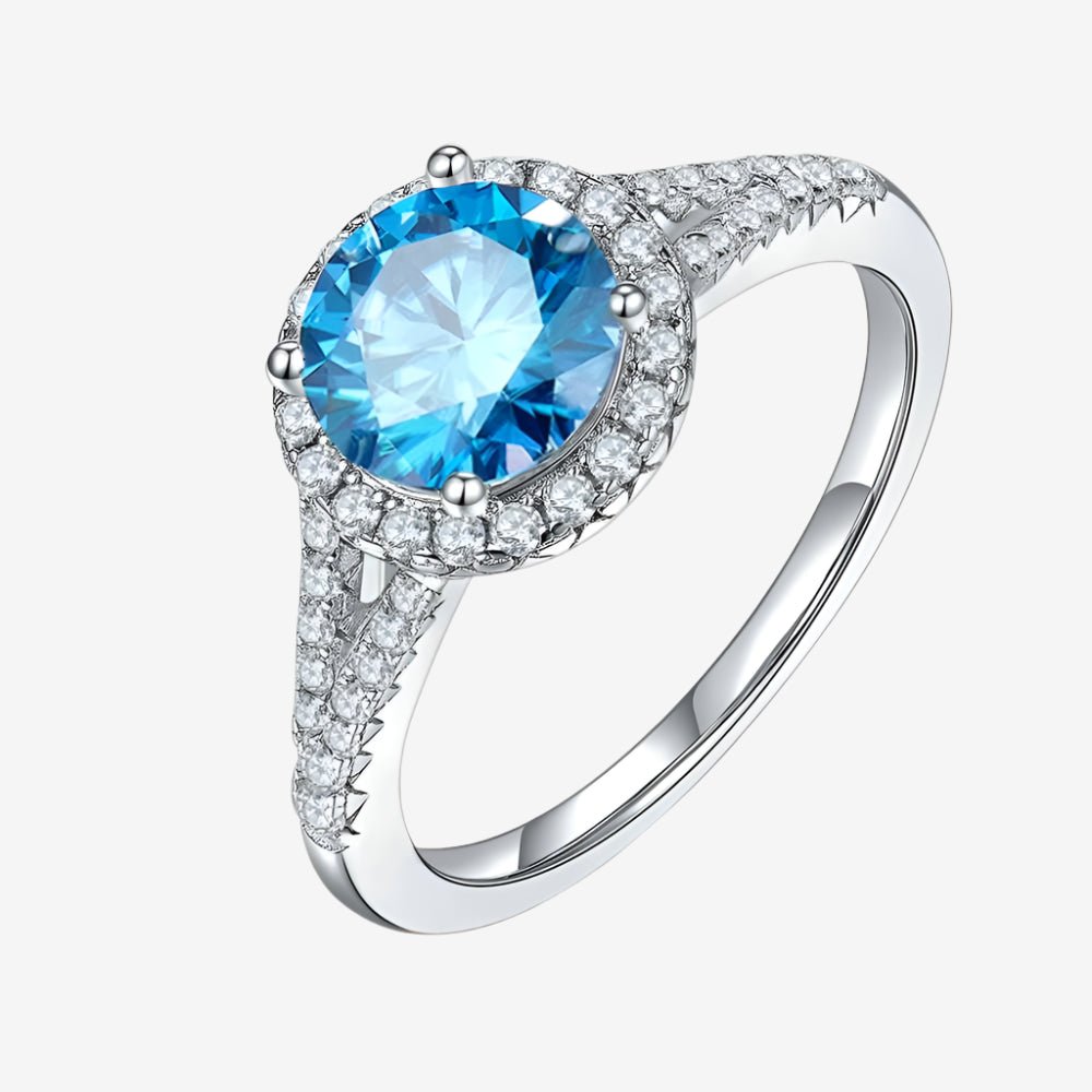 Stunning moissanite engagement ring with a blue center stone and sparkling pave band. 💍✨ Gorgeous choice for weddings!
