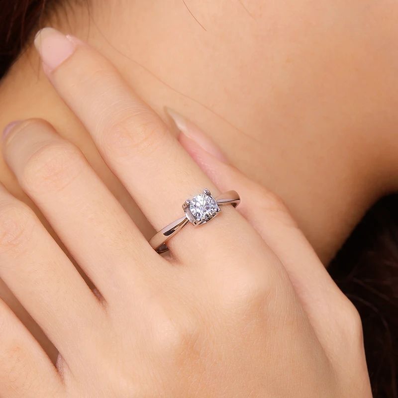 Elegant 0.5CT round-cut Moissanite ring on hand 💍✨, perfect for engagement or wedding, showcasing amazing value.