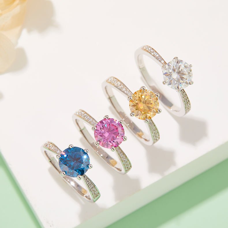 Four stunning rings featuring colorful gemstones: blue, pink, yellow, and clear moissanite accents 💍💖✨
