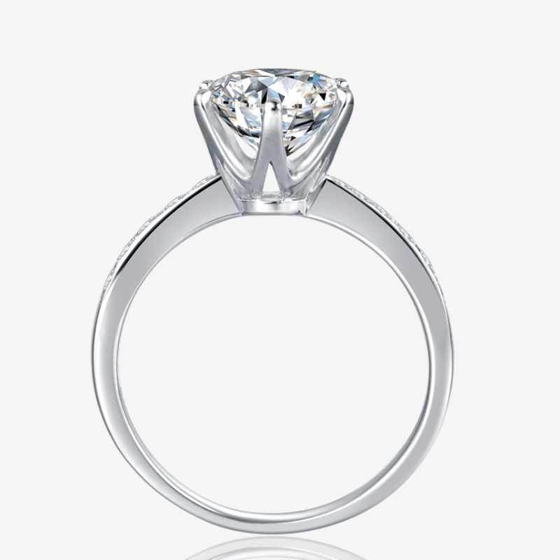 The Calvienne Round-Cut Moissanite Ring in sterling silver, featuring a dazzling 3CT stone and zirconia accents. 💍✨