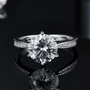 Moissanite engagement ring with round-cut center stone, 925 sterling silver band, 16 zirconia accents, amazing value! 💍✨