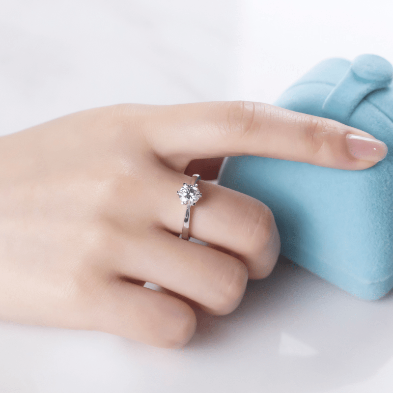 The Camille Moissanite solitaire engagement ring on a hand, showcasing its 1CT brilliance 💍✨. Ideal for weddings and amazing value! 💖