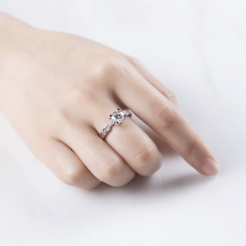 Elegant hand wearing The Celestara ring with 1.0CT moissanite, perfect for weddings or engagements. 💍✨ Amazing value!