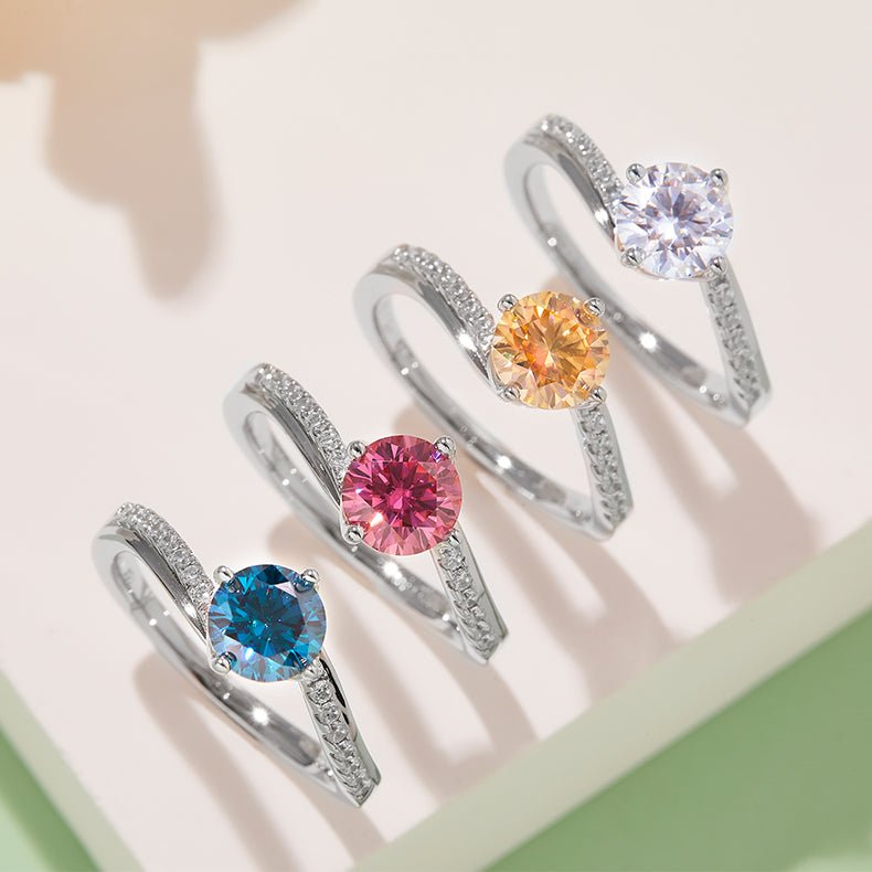 Colorful sapphire twist rings with sparkling stones in pink, blue, orange, and white on elegant bands. 💍✨ #Moissanite #Engagement #Wedding
