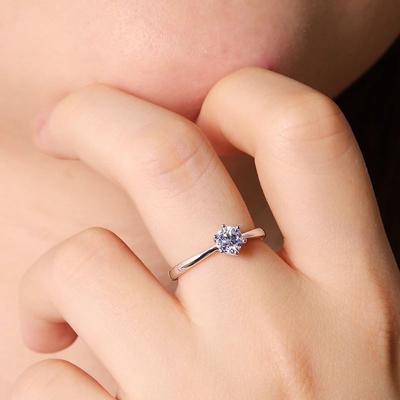Elegant hand wearing The Eloria Moissanite solitaire ring 💍✨. Perfect for engagement and wedding, amazing value!