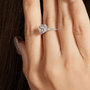 💍 Hand wearing The Evelora Moissanite Halo Ring with a sparkling center stone and pavé band. Elegant engagement or wedding ring. ✨