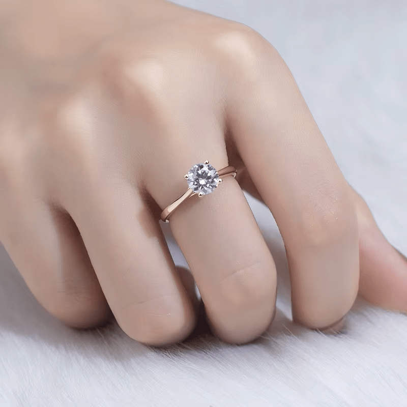 Close-up of The Everly round cut Moissanite solitaire ring on hand 💍✨ Perfect for engagements & weddings!