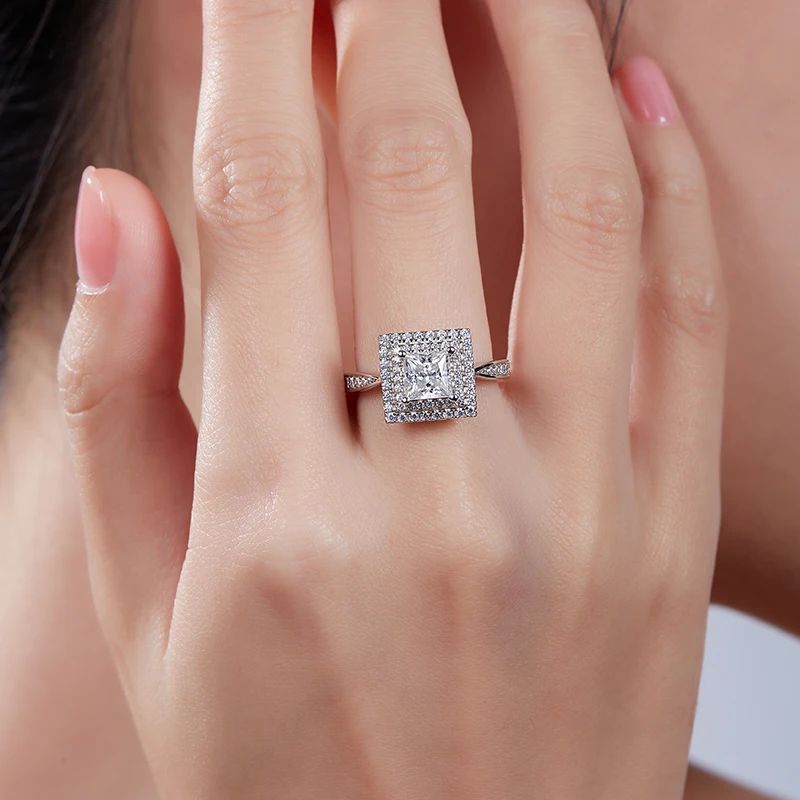 Meliora Princess-Cut Moissanite Halo Ring 💍✨ on a hand, showcasing stunning sparkle and elegance for weddings & engagements.
