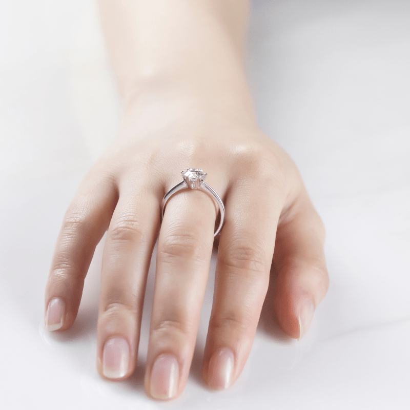 Elegant hand wearing The Selene Moissanite engagement ring 💍✨, showcasing its captivating sparkle and modern design.