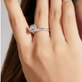 Beautiful hand wearing The Seraphina moissanite halo engagement ring 💍✨, featuring a 1.0ct center stone and floral halo.