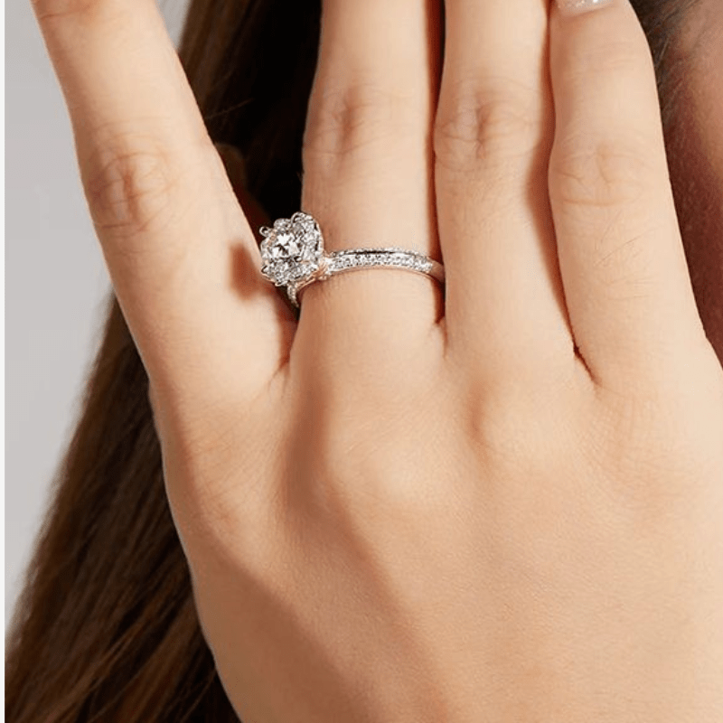 Beautiful hand wearing The Seraphina moissanite halo engagement ring 💍✨, featuring a 1.0ct center stone and floral halo.