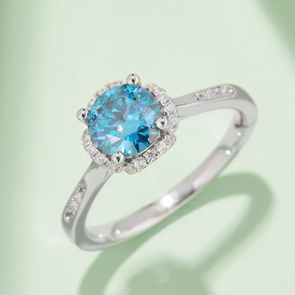 Stunning teal Moissanite engagement ring with halo setting and pavé accents. 💍✨ Perfect for weddings! #AmazingValue