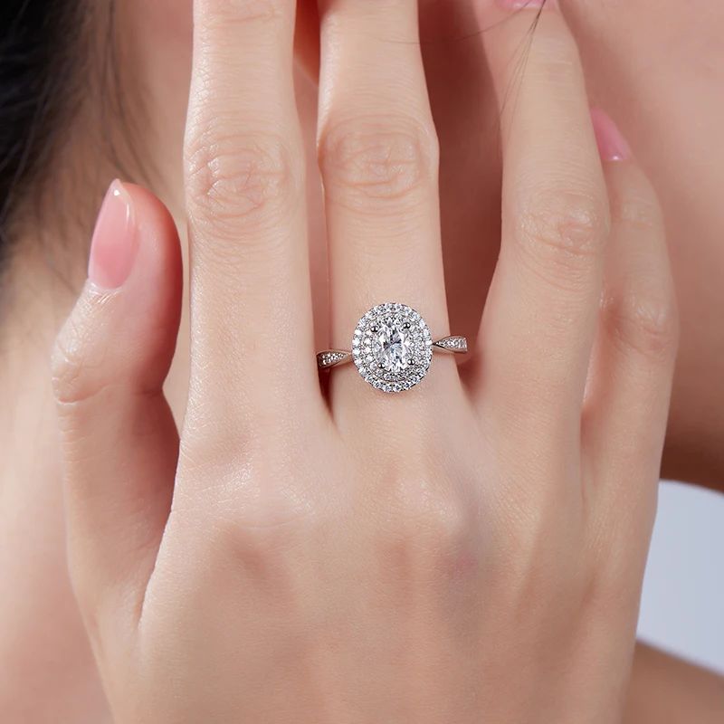 Oval-cut Moissanite halo ring on a hand 💍, perfect for engagements or weddings 🌟, showcasing amazing value and elegance.