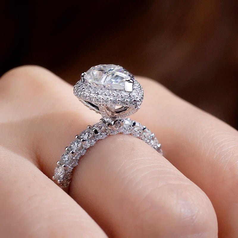 Close-up of The Zephyra Moissanite halo engagement ring, showcasing its dazzling 3CT pear-cut gem and sparkling band. ✨💍